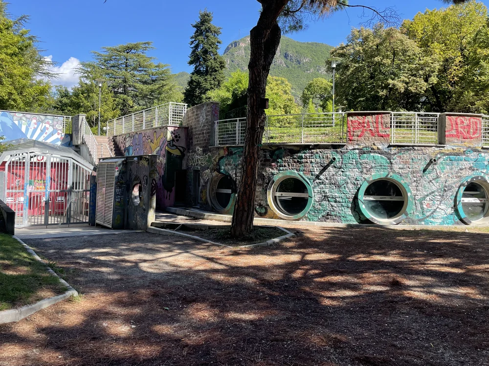 Pippo Stage from the park: the graffiti wall with its round windows